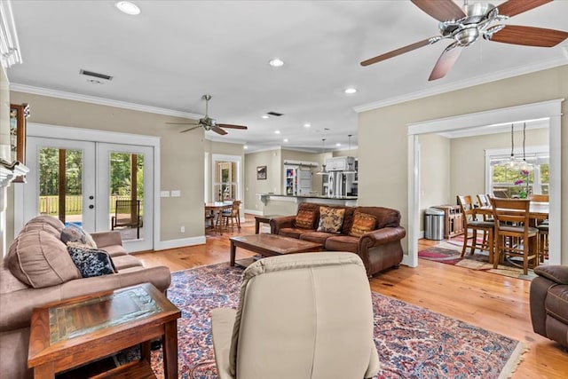 3195 Singletary Rd, Slocomb, AL 36375 - living area with ceiling fan, plenty of natural light, ornamental molding, french doors, and light wood-style flooring
