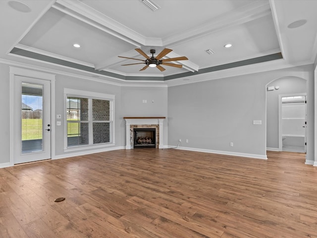 unfurnished living room with coffered ceiling, a ceiling fan, hardwood / wood-style flooring, arched walkways, and crown molding