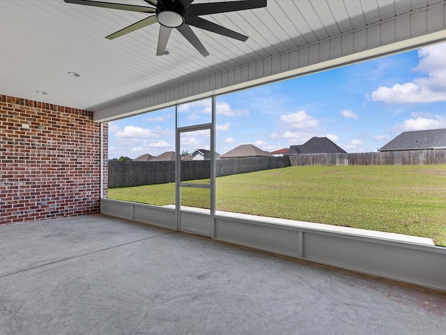 unfurnished sunroom with a ceiling fan