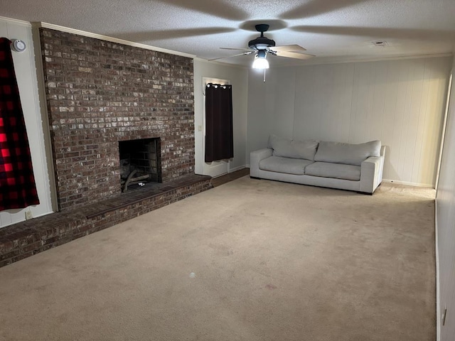 unfurnished living room featuring a textured ceiling, ceiling fan, light colored carpet, ornamental molding, and a brick fireplace