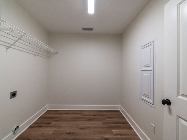 washroom with laundry area, baseboards, visible vents, dark wood-style flooring, and hookup for an electric dryer