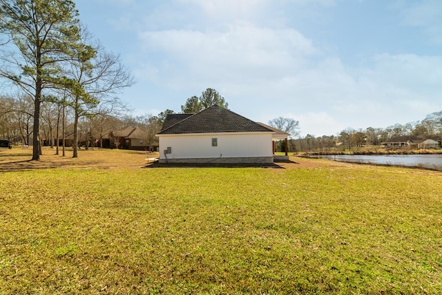 view of home's exterior featuring a water view and a yard