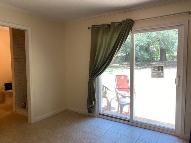 2308 Debbie Dr, Dothan, AL 36301 - doorway to outside featuring ornamental molding, healthy amount of natural light, and light tile patterned floors