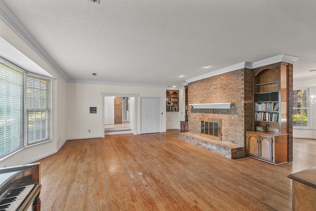 unfurnished living room featuring baseboards, a brick fireplace, ornamental molding, a textured ceiling, and wood finished floors