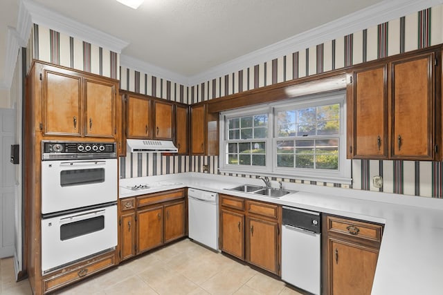kitchen with wallpapered walls, a sink, white appliances, and under cabinet range hood