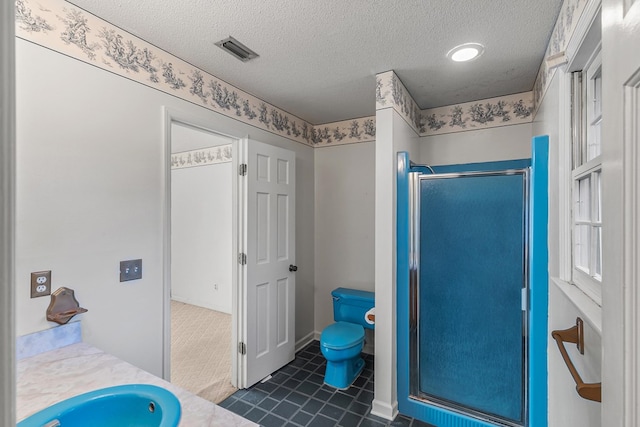 bathroom featuring visible vents, toilet, a textured ceiling, a shower stall, and tile patterned floors