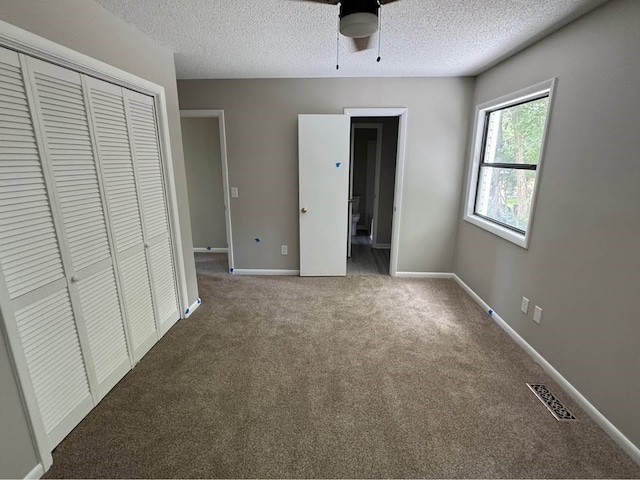 107 Comanche Cir, Enterprise, AL 36330 - unfurnished bedroom featuring carpet floors, a textured ceiling, a closet, and a ceiling fan