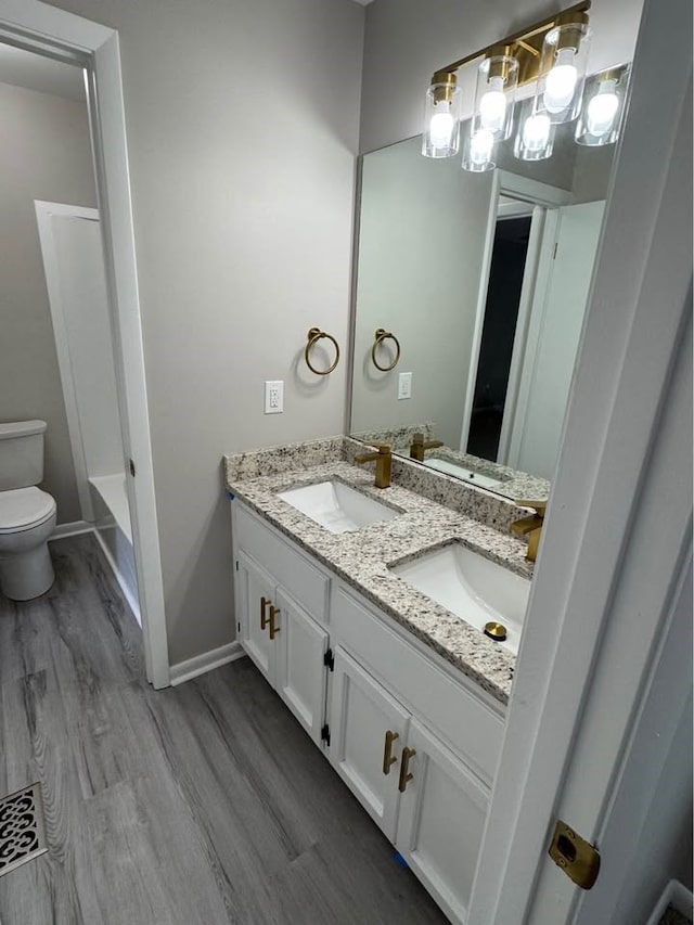 107 Comanche Cir, Enterprise, AL 36330 - bathroom featuring double vanity, wood finished floors, a bath, a chandelier, and a shower