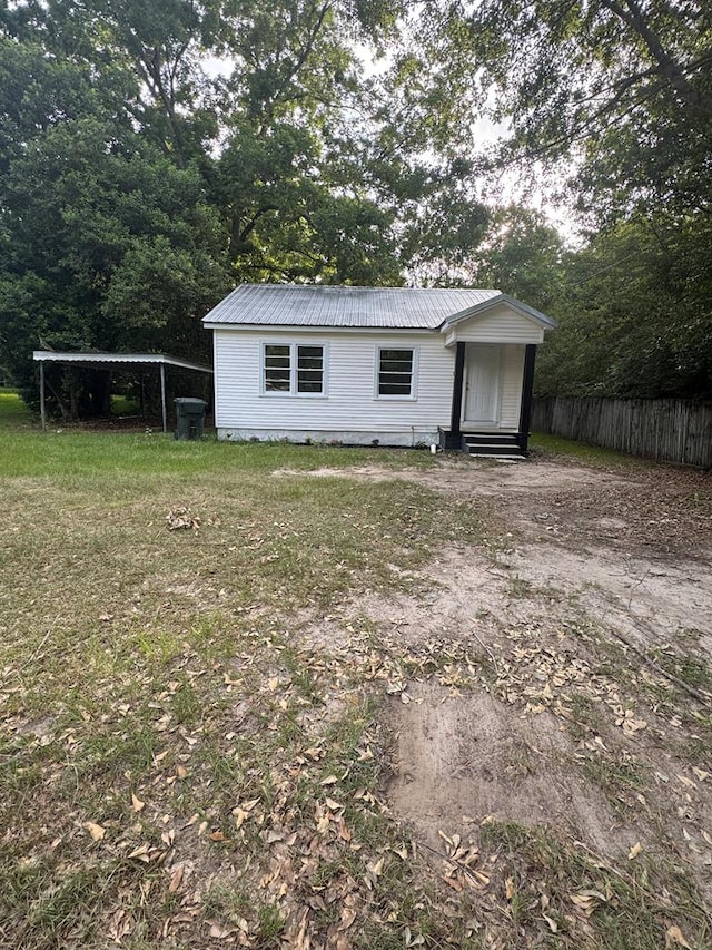1208 Jonathan St, Dothan, AL 36301 - view of front of house with entry steps, a metal roof, and a detached carport
