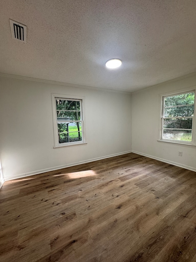 1208 Jonathan St, Dothan, AL 36301 - spare room with a textured ceiling, dark wood finished floors, and ornamental molding