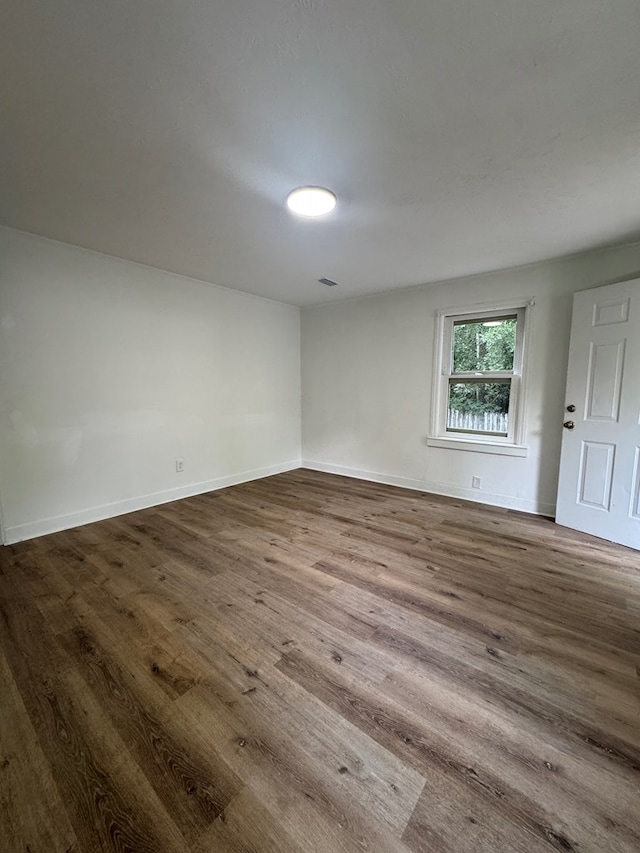 1208 Jonathan St, Dothan, AL 36301 - empty room with dark wood-type flooring and baseboards
