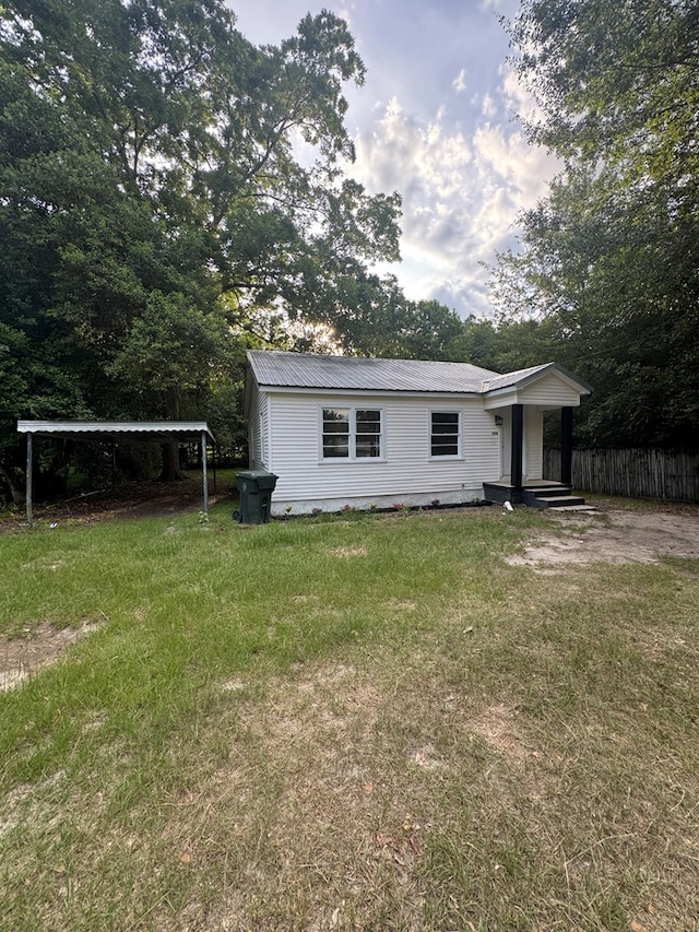 1208 Jonathan St, Dothan, AL 36301 - rear view of house featuring a detached carport and a metal roof