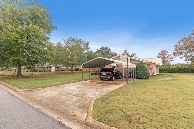 view of parking / parking lot featuring a yard and a carport