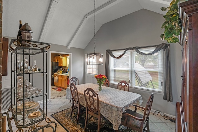 dining room with vaulted ceiling with beams, plenty of natural light, and light tile patterned flooring