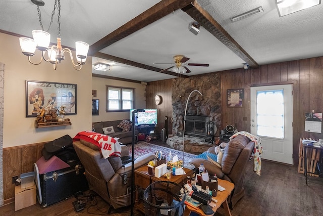 living room with ceiling fan with notable chandelier, a textured ceiling, wood-type flooring, beam ceiling, and wood walls