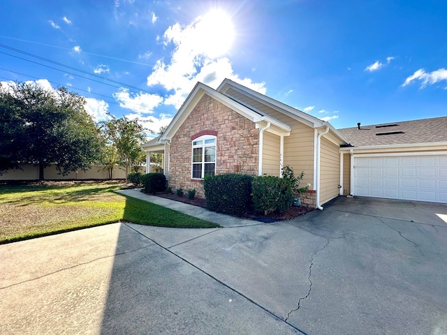 view of home's exterior featuring a lawn and a garage