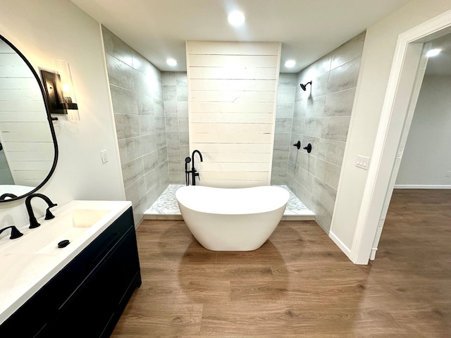 bathroom featuring hardwood / wood-style floors, vanity, and separate shower and tub