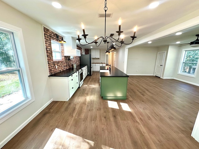 kitchen with white cabinetry, plenty of natural light, decorative light fixtures, and an inviting chandelier