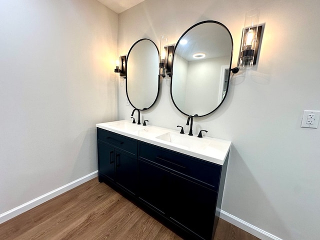 bathroom featuring hardwood / wood-style flooring and vanity