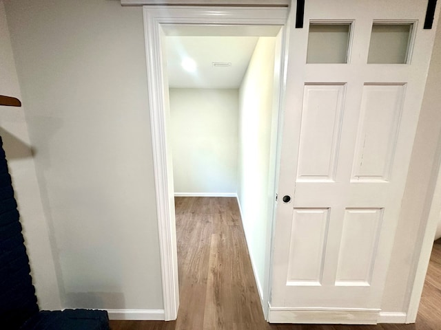 hallway with light hardwood / wood-style flooring