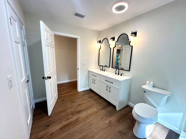 bathroom featuring hardwood / wood-style floors, vanity, and toilet