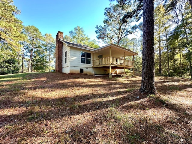 back of house with a deck