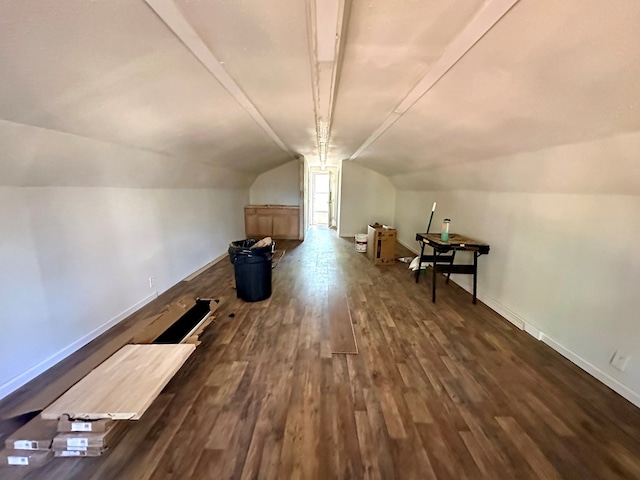 additional living space featuring dark hardwood / wood-style flooring and vaulted ceiling