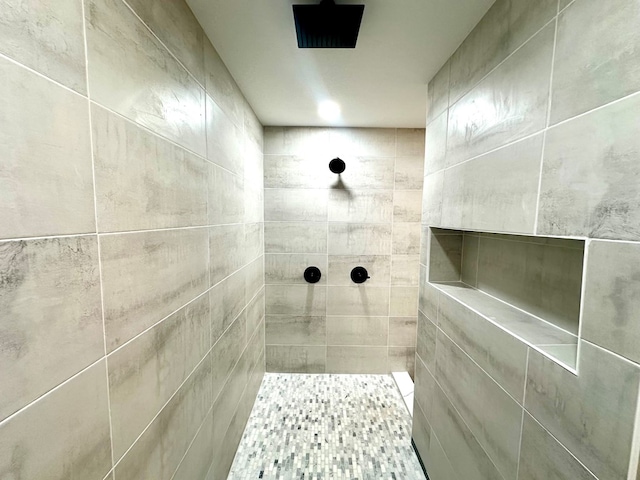 bathroom with tiled shower