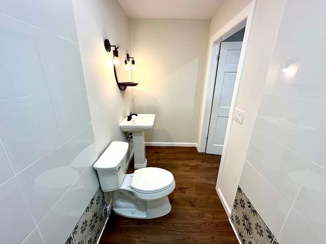 bathroom with hardwood / wood-style floors, toilet, and sink