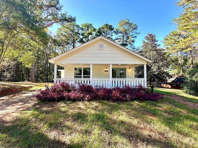 bungalow-style house with a front yard and a porch