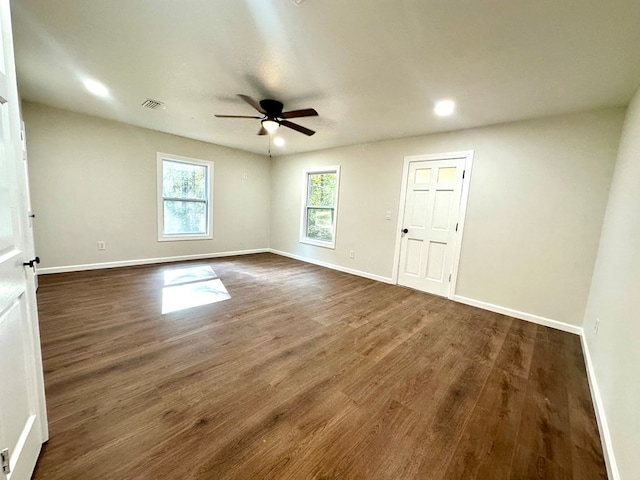 unfurnished room with dark hardwood / wood-style floors and ceiling fan