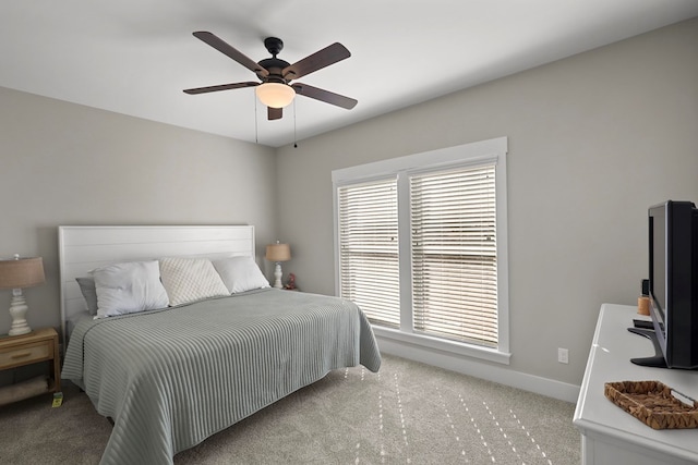 bedroom featuring light colored carpet and ceiling fan