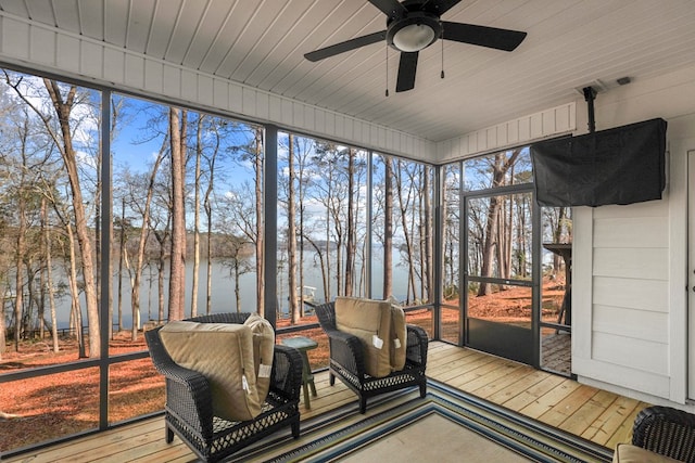 sunroom featuring a water view, plenty of natural light, wood ceiling, and ceiling fan