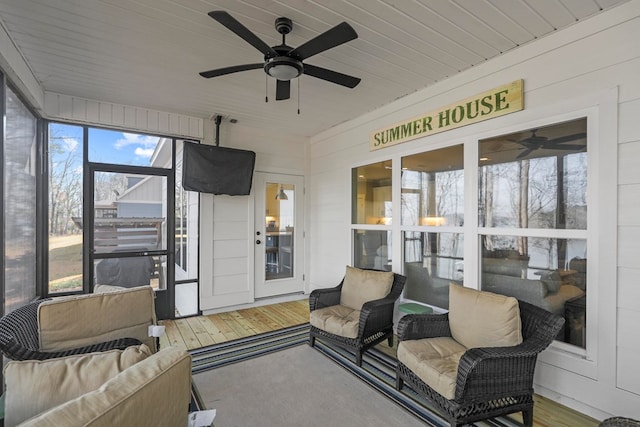 sunroom / solarium featuring wooden ceiling and ceiling fan