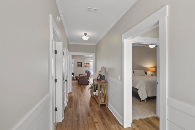 hallway featuring crown molding and hardwood / wood-style floors