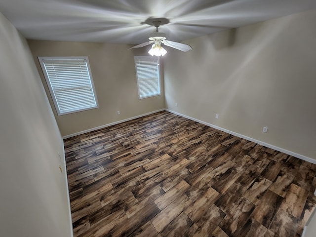 unfurnished room featuring ceiling fan and dark wood-type flooring