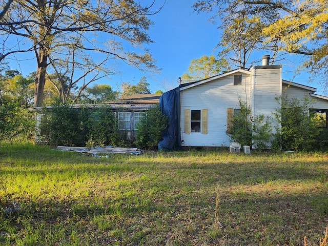 view of property exterior with a yard