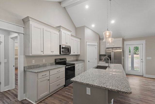 kitchen featuring dark hardwood / wood-style floors, stainless steel appliances, a kitchen island with sink, and sink