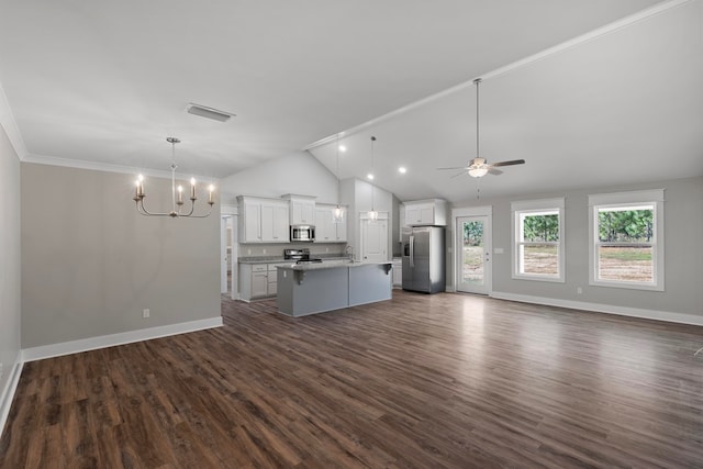 unfurnished living room with ceiling fan with notable chandelier, vaulted ceiling, dark wood-type flooring, sink, and crown molding