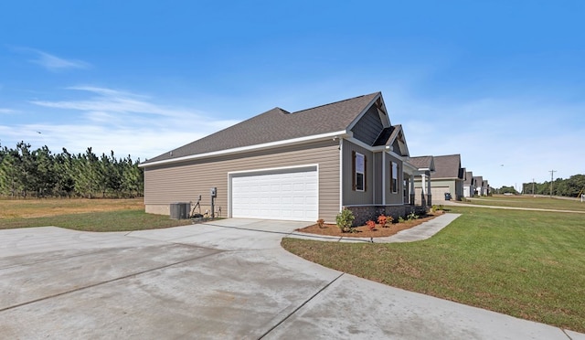 view of side of home with a garage, a yard, and central air condition unit