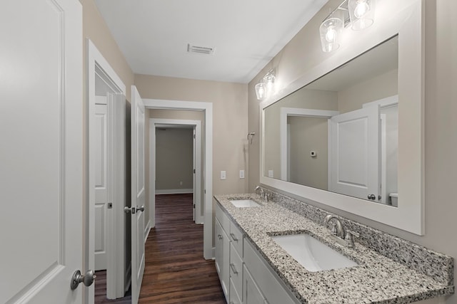 bathroom with hardwood / wood-style floors and vanity