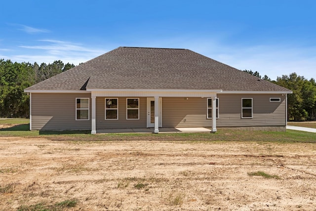 rear view of property with a lawn