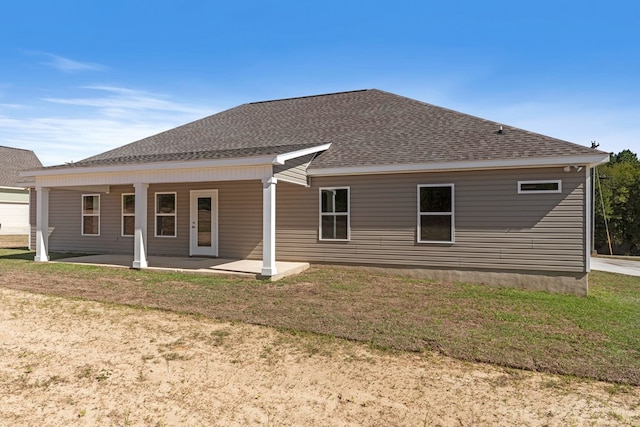 back of property with a lawn and covered porch