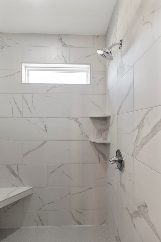 bathroom with a tile shower