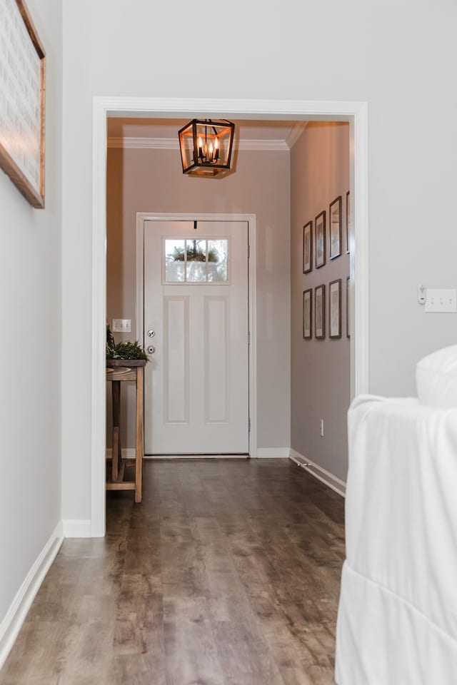 entrance foyer with crown molding and a notable chandelier