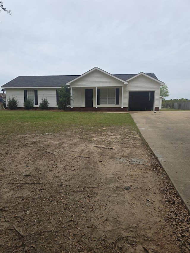 ranch-style home with a front lawn, an attached garage, and concrete driveway