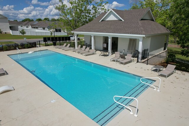318 Oconee Dr, Midland City, AL 36350 - community pool featuring a patio area, fence, and an outdoor structure