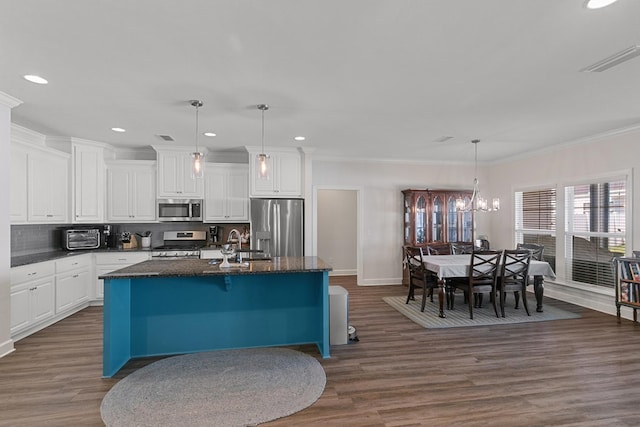 318 Oconee Dr, Midland City, AL 36350 - kitchen with appliances with stainless steel finishes, dark wood-type flooring, a center island with sink, recessed lighting, and white cabinets