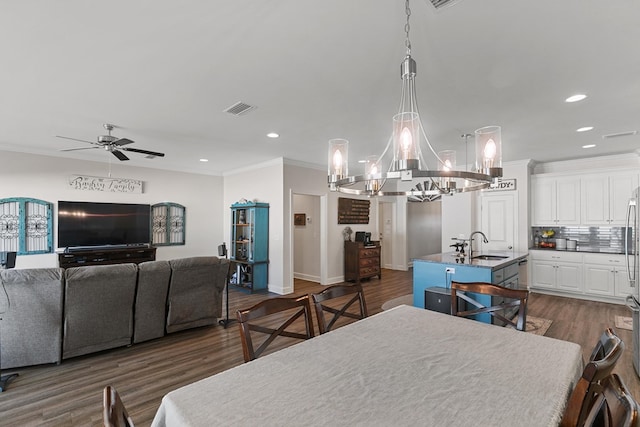 318 Oconee Dr, Midland City, AL 36350 - dining area with ornamental molding, ceiling fan, dark wood finished floors, recessed lighting, and a chandelier