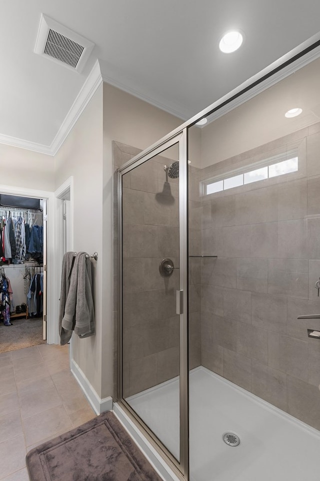 318 Oconee Dr, Midland City, AL 36350 - full bathroom featuring ornamental molding, a stall shower, a walk in closet, tile patterned flooring, and baseboards